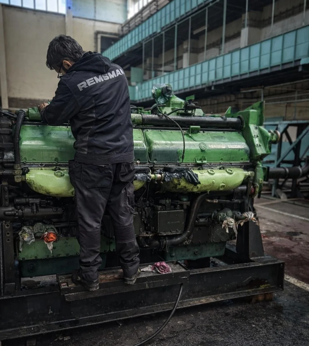 REMSMAR engineer inspecting a large marine diesel engine