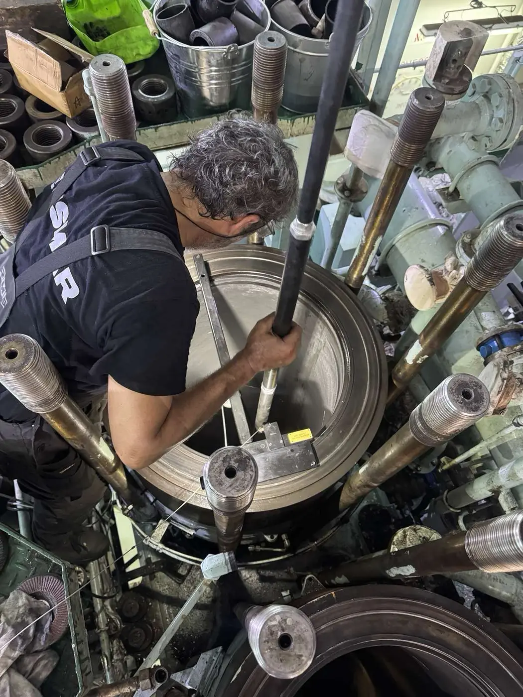 Technician measuring a marine engine cylinder liner